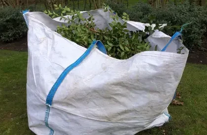 Green waste collection Perth – large garden waste bag filled with trimmed branches and leaves ready for eco-friendly disposal